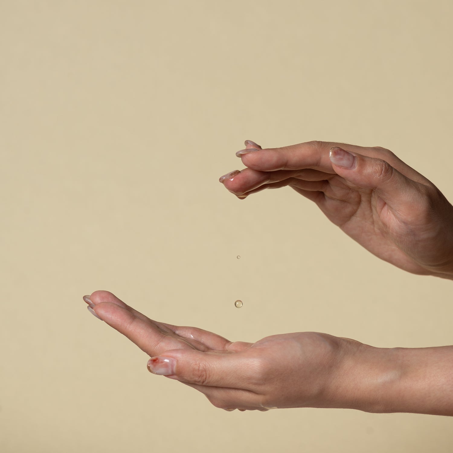 Essential Oil suspends in air with hands.